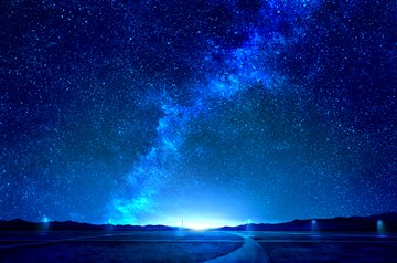 Milky way, road with lights in the distance by mks