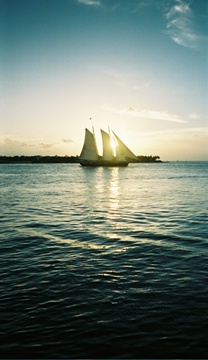 Sun shining through sailboat sails