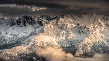 north-west Grand Replomb in sunset, Belledonne Range, French Alps in winter, dark clouds
