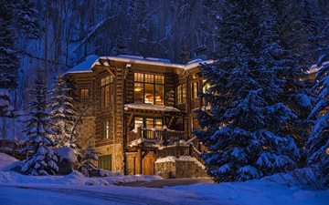 log home in winter evening, Colorado, USA
