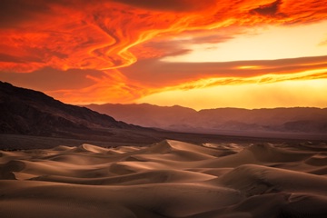 a dramatic sunset above the Mesquite sand dunes in Death Valley NP, California, USA