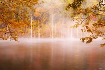 Magic autumn, haze over lake
