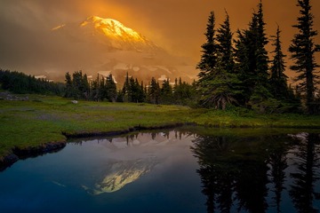 sunset Mount Rainier from a tarn near the Spray Park Trail, Washington, USA
